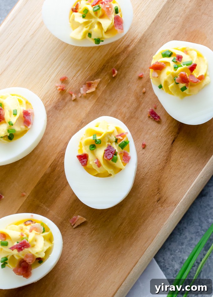 Deviled eggs topped with bacon and chives