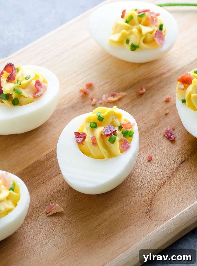 Deviled eggs with bacon on a wooden board