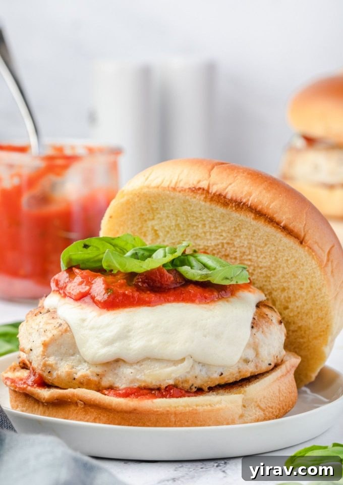 Juicy ground chicken burger topped with vibrant marinara, melted mozzarella, and fresh basil