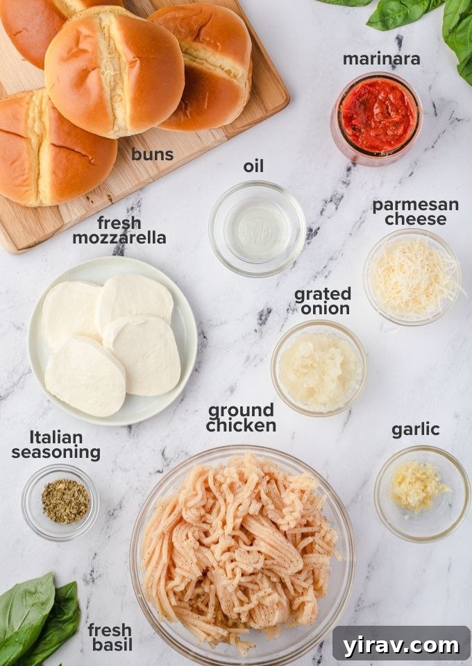 Individual ingredients laid out for ground chicken burgers including ground chicken, cheese, onion, and seasoning