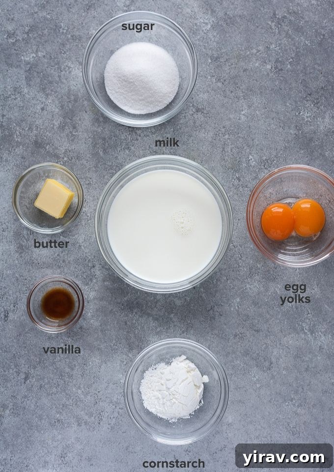 Pastry cream ingredients for fruit tart cupcakes, including milk, eggs, sugar, and vanilla bean paste.