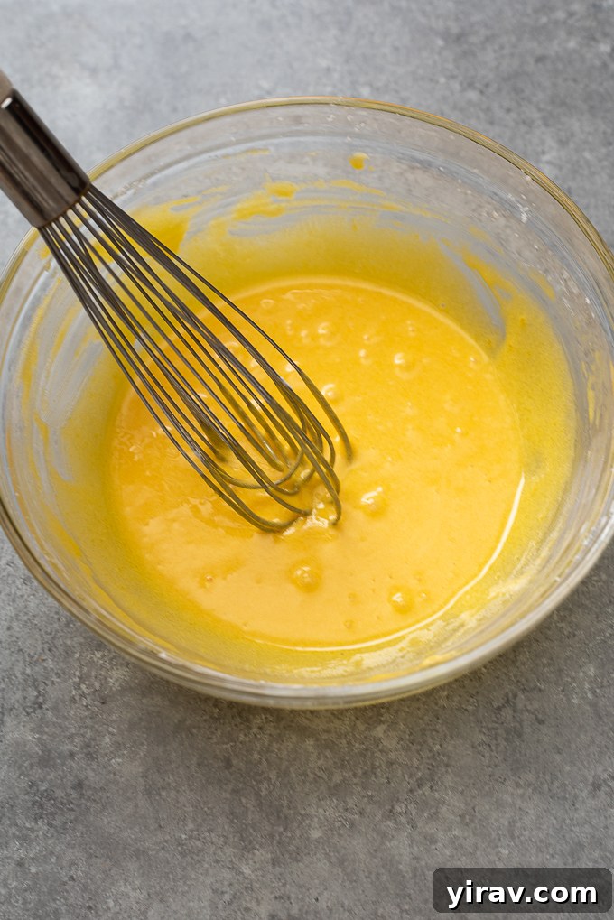 Whisked egg yolks, sugar and cornstarch in a bowl, a key step for smooth pastry cream.