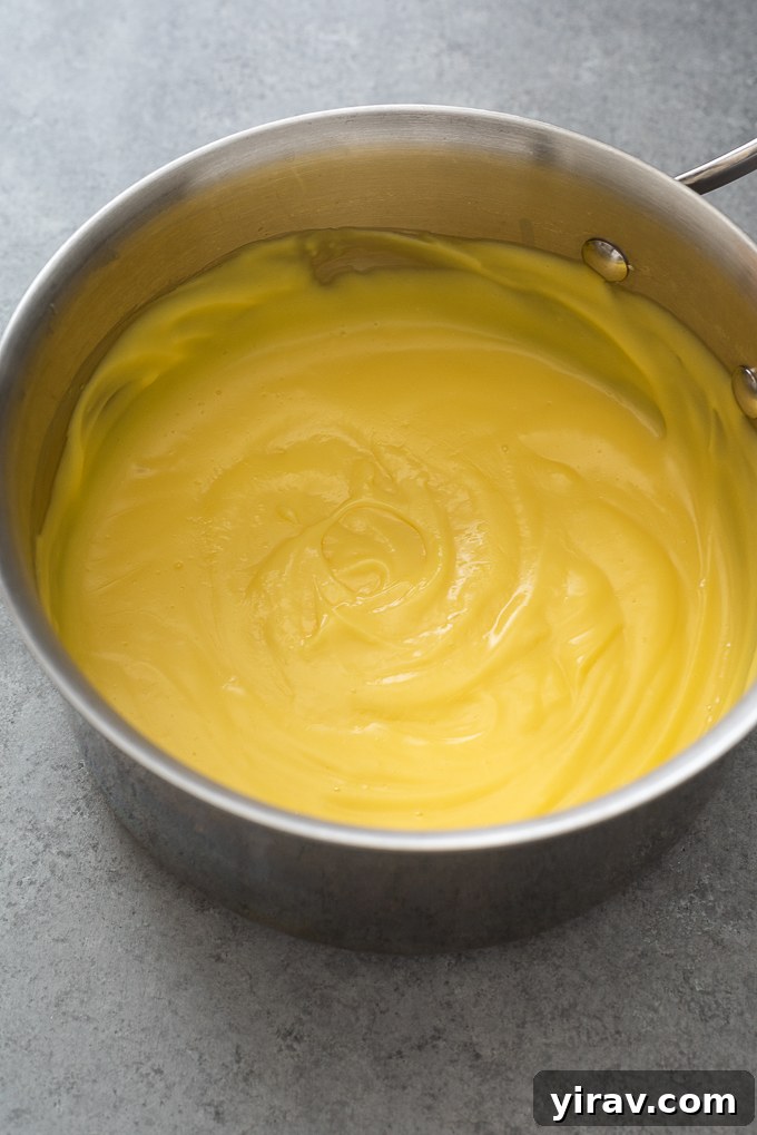 Cooked pastry cream in a saucepan, showing its thickened texture after boiling.