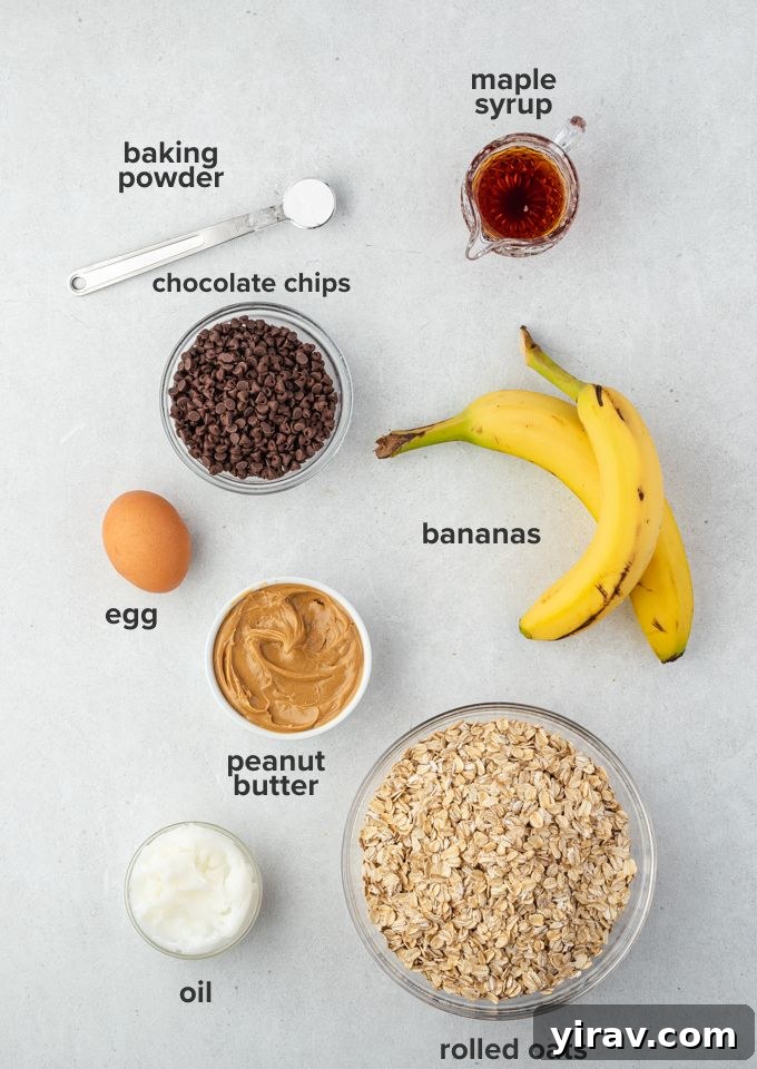 Selection of ingredients for banana peanut butter oatmeal bars: oats, bananas, peanut butter, oil, maple syrup, egg, baking powder, chocolate chips