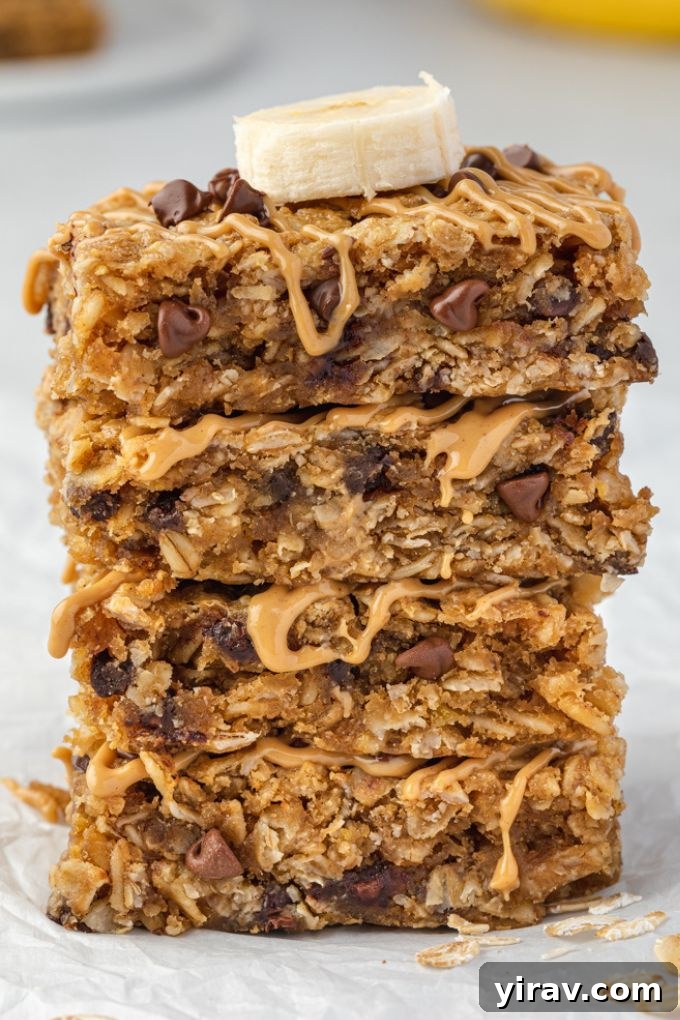 Stack of peanut butter banana oatmeal bars on a wooden surface