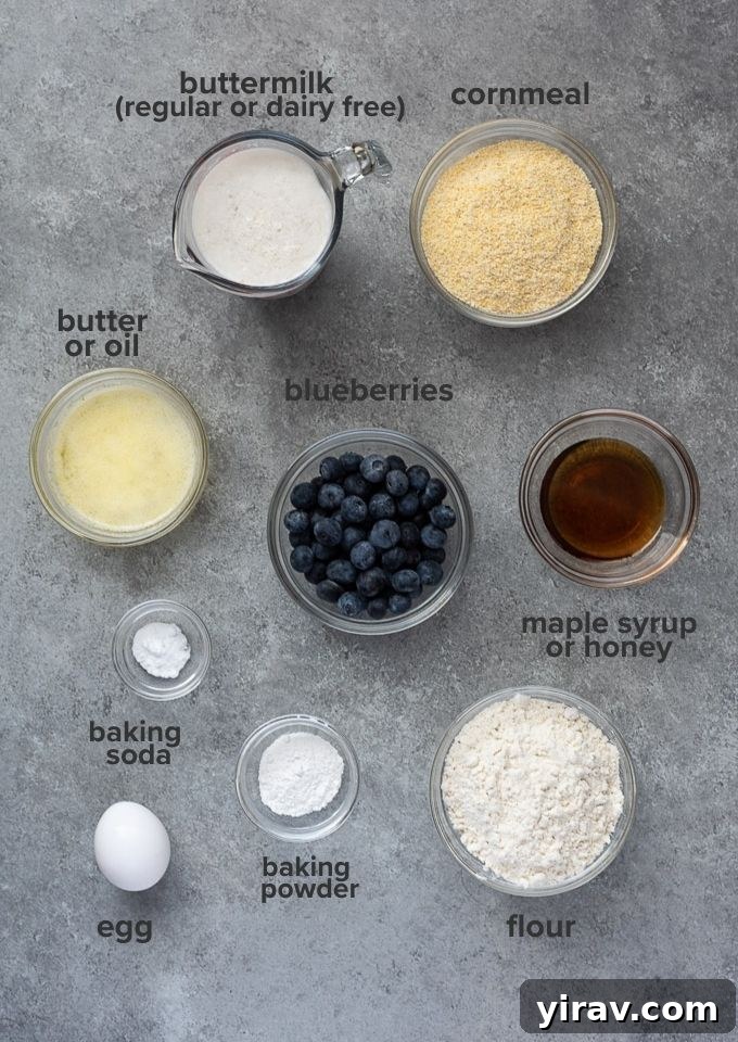 A visual collage displaying all the fresh ingredients for Skillet Blueberry Cornbread, including flour, cornmeal, blueberries, butter, maple syrup, and buttermilk.