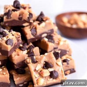 Squares of chocolate peanut butter fudge piled on a white plate