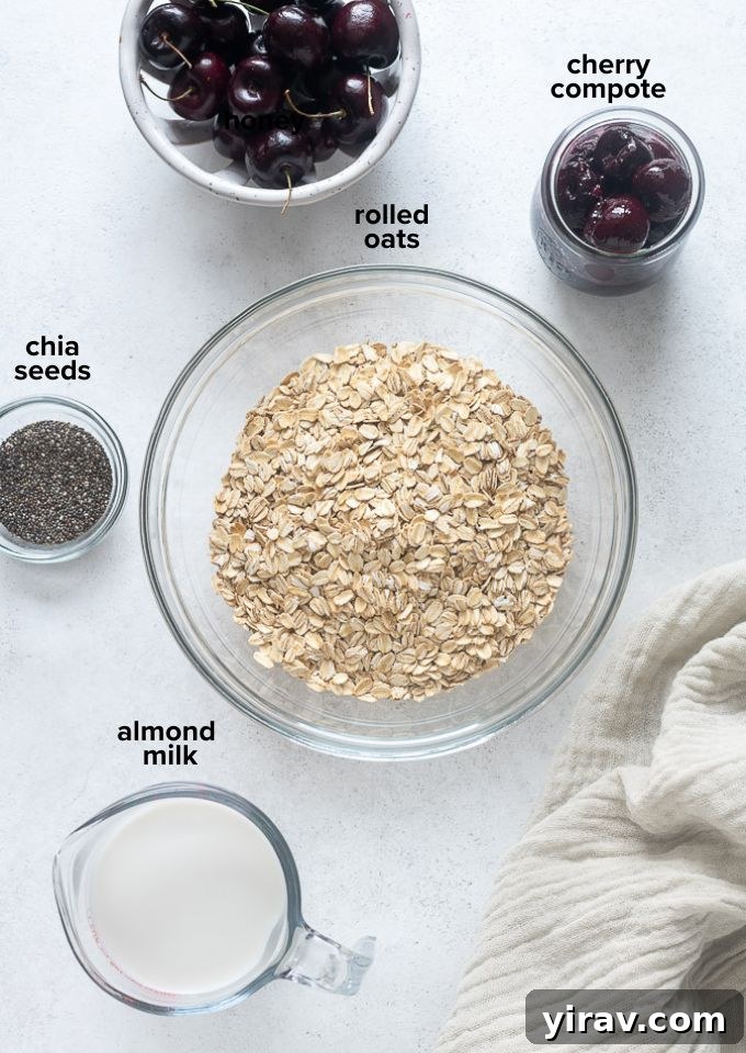 Close-up of fresh cherries, rolled oats, almond milk, and chia seeds – the key ingredients for cherry pie overnight oats.