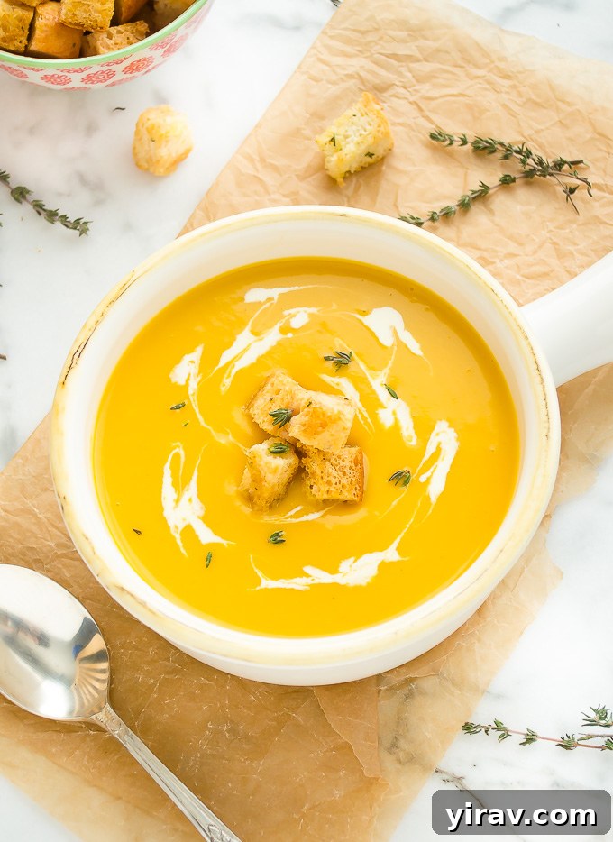 Rich butternut squash potato soup served in a bowl, showcasing its smooth texture and elegant creamy swirls, a healthy and gluten-free delight.