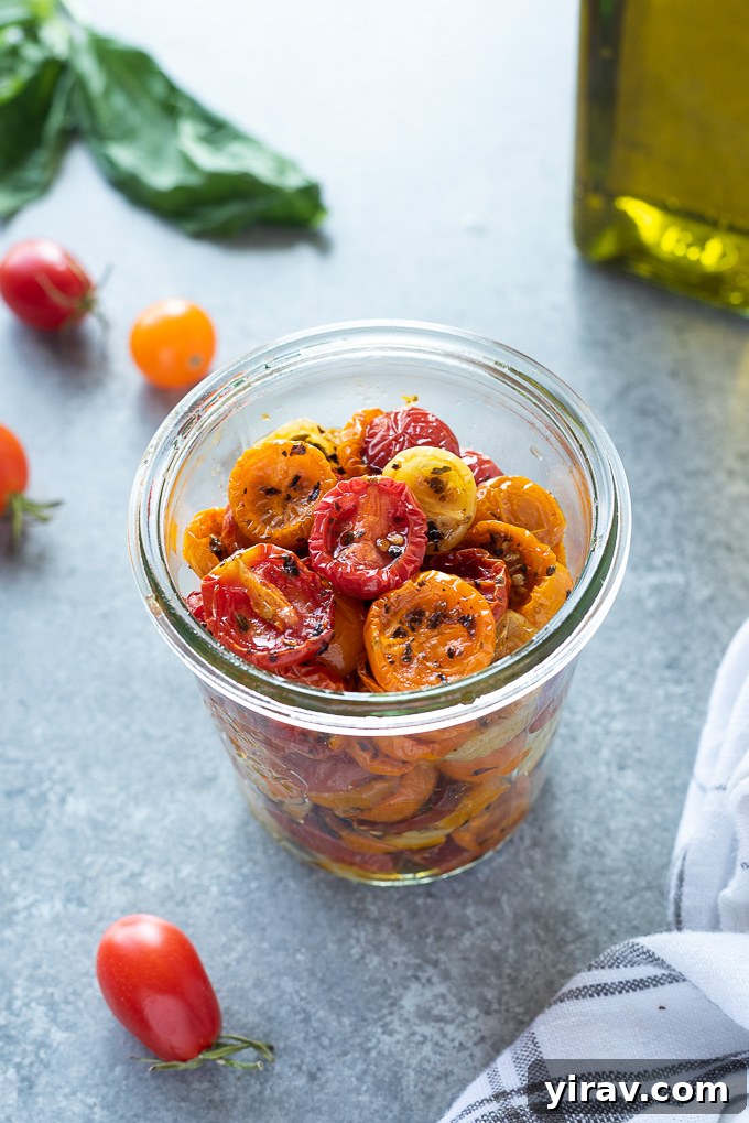 Slow roasted cherry tomatoes in a jar with linen alongside