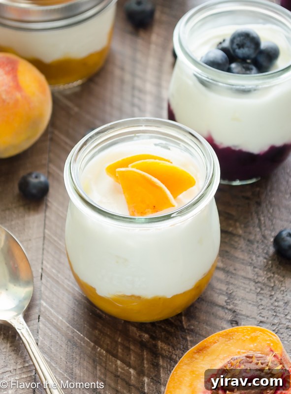 Various jars of Fruit on the Bottom Yogurt, some topped with fresh fruit slices, showcasing a delightful and healthy snack or breakfast option.