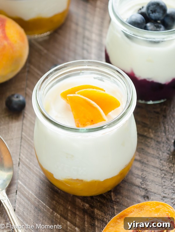 Close-up of a Homemade Fruit on the Bottom Yogurt Cup featuring creamy yogurt layered over a rich peach compote, garnished with fresh peach slices for an appealing and healthy treat.