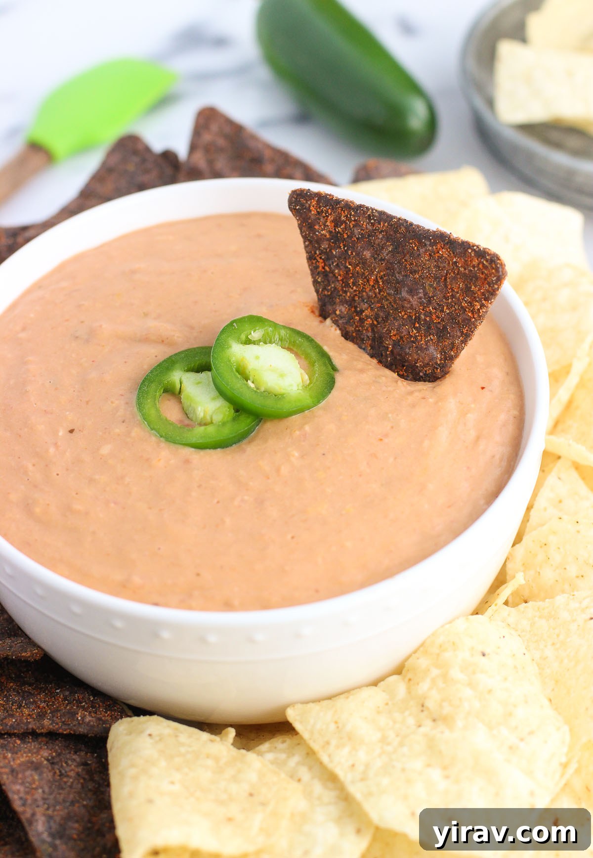 31 Tailgating Snacks That Steal the Show 14 A generous serving of cheesy salsa bean dip, ready to be enjoyed with chips or crackers.