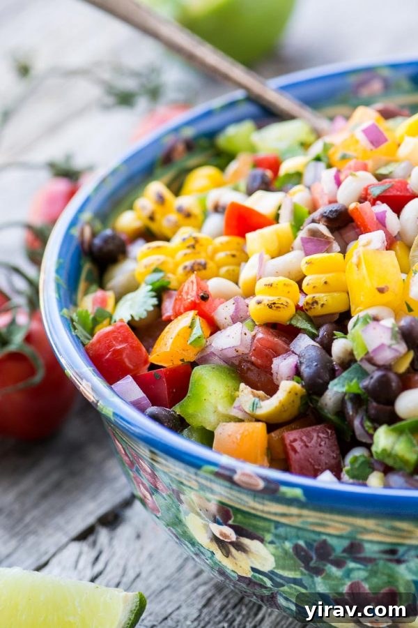 31 Tailgating Snacks That Steal the Show 16 A bowl brimming with colorful cowboy caviar, a vibrant mix of beans and vegetables.