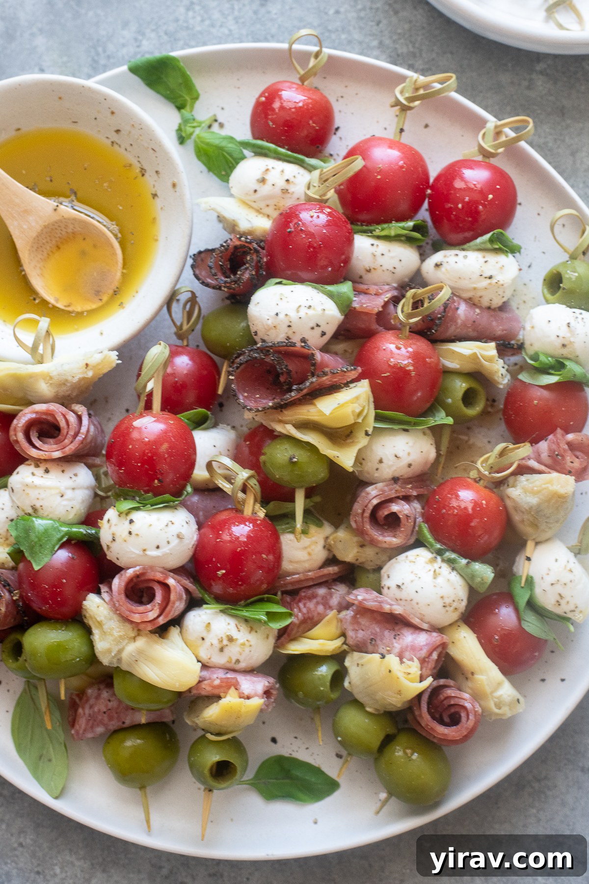 31 Tailgating Snacks That Steal the Show 25 An array of mini Italian antipasto skewers, beautifully arranged and drizzled with a light Italian dressing.