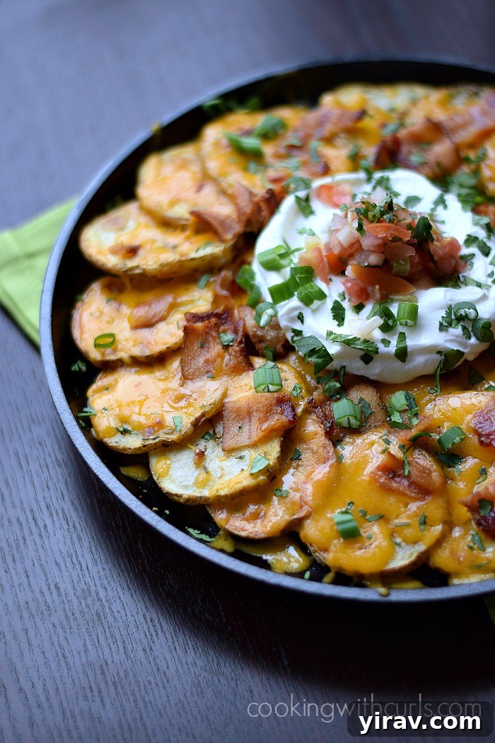 31 Tailgating Snacks That Steal the Show 27 A plate of hearty Irish nachos, served with a dollop of sour cream.