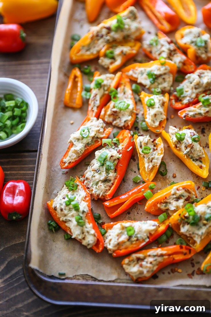 31 Tailgating Snacks That Steal the Show 8 Caramelized onion and cream cheese stuffed peppers arranged on a baking sheet.