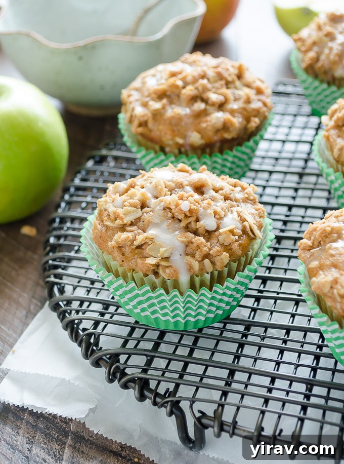 A freshly baked apple crumble muffin drizzled with a sweet glaze, ready to be enjoyed.