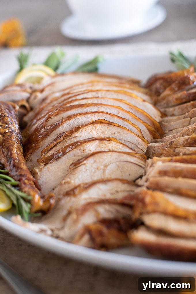 The Ultimate Dry Brined Roast Turkey 6 Slices of perfectly roasted dry-brined turkey arranged on a serving platter, showcasing its juicy interior and crispy skin.