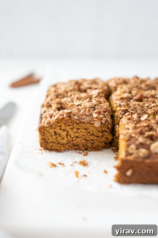 Perfectly sliced pumpkin coffee cake squares arranged on a elegant marble board, ready to be enjoyed as a comforting treat.