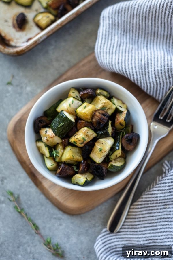Overhead shot of fresh zucchini, cremini mushrooms, and thyme, key ingredients for roasting