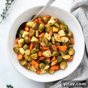 Roasted brussels sprouts and carrots in a bowl with thyme