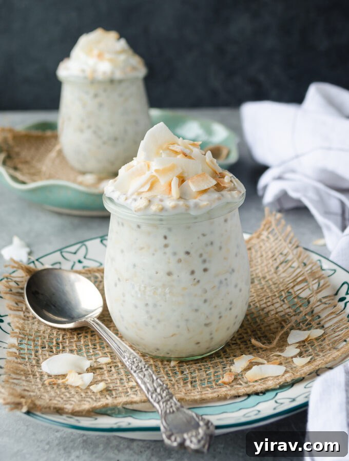 Creamy coconut overnight oats in glass jars, topped with toasted coconut flakes, ready for a healthy and delicious breakfast.