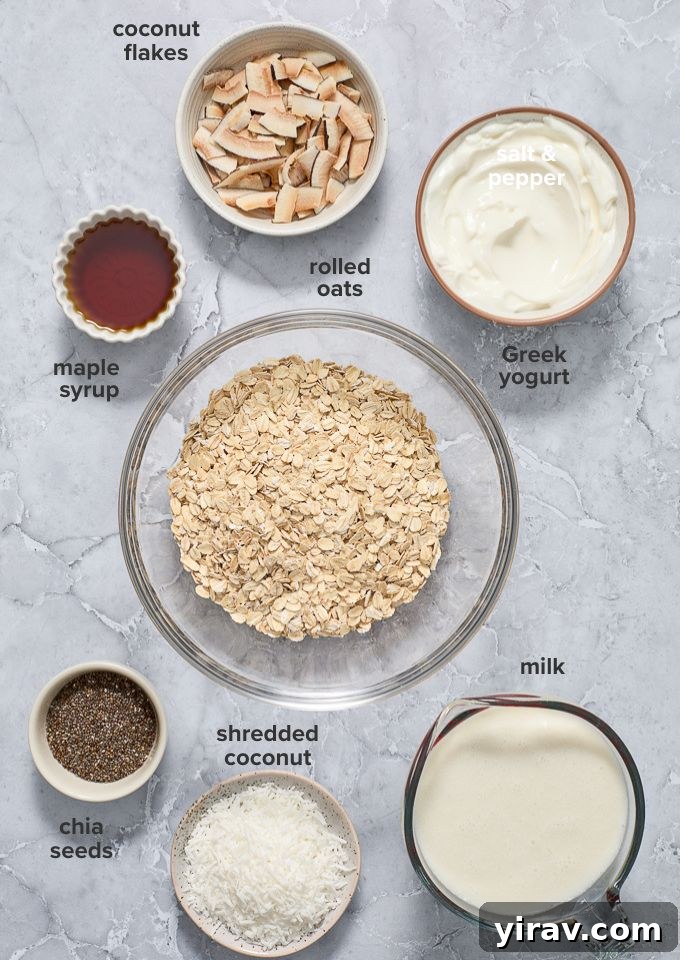 Layout of ingredients for coconut chia overnight oats, including oats, chia seeds, coconut milk, maple syrup, Greek yogurt, and shredded coconut.