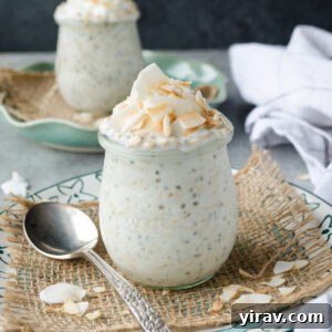 Coconut overnight oats in jars with coconut flakes on top.