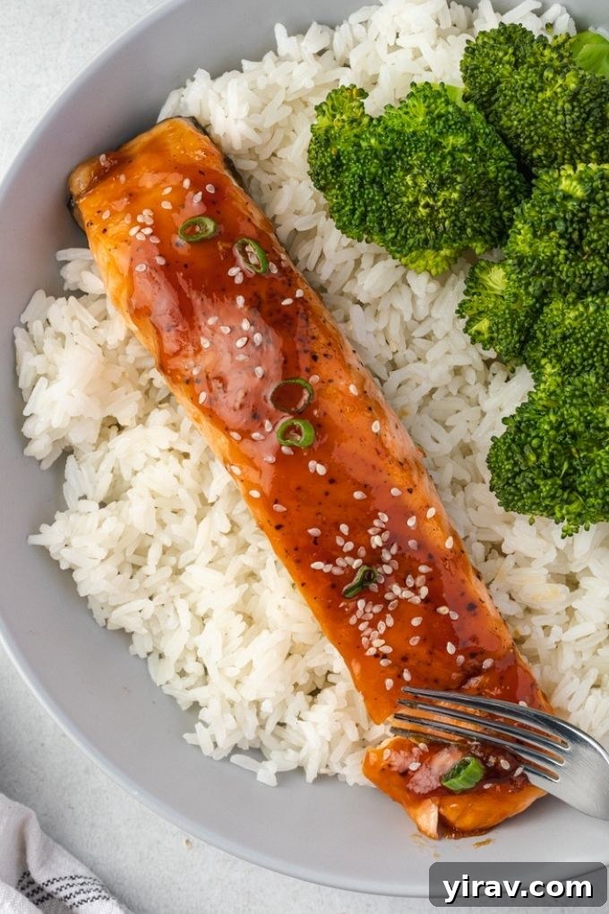Glazed Teriyaki Salmon 3 Baked teriyaki salmon garnished with sesame seeds and scallions, served with rice and vibrant broccoli