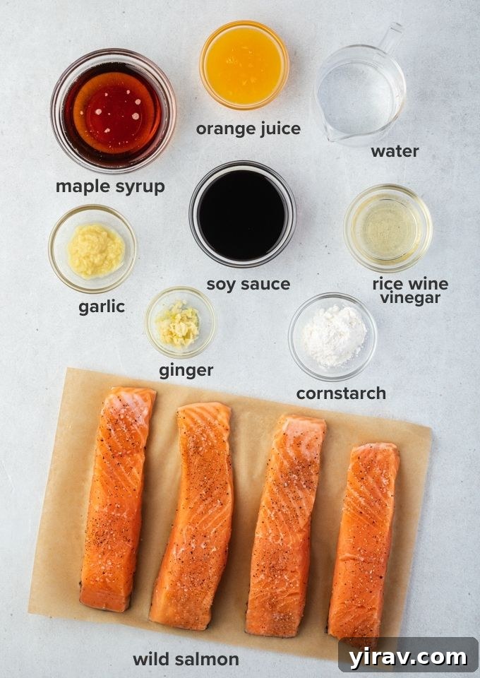 Glazed Teriyaki Salmon 4 All the fresh ingredients laid out for making teriyaki salmon, including salmon fillets, ginger, garlic, soy sauce, and orange.