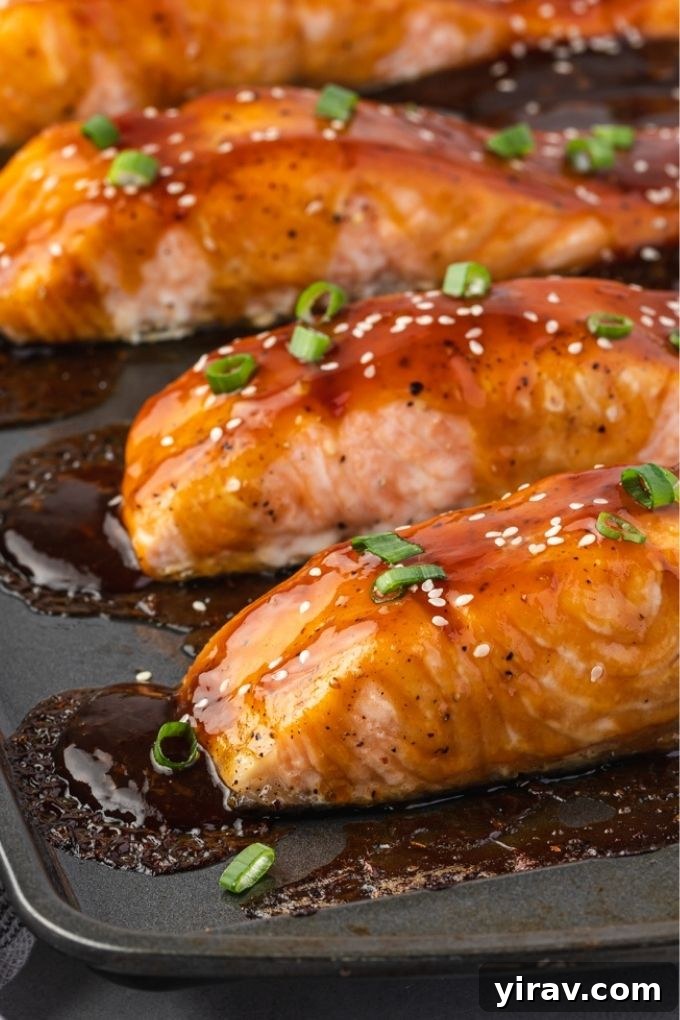 Glazed Teriyaki Salmon 6 Succulent baked teriyaki salmon fillets on a sheet pan, ready to be served.