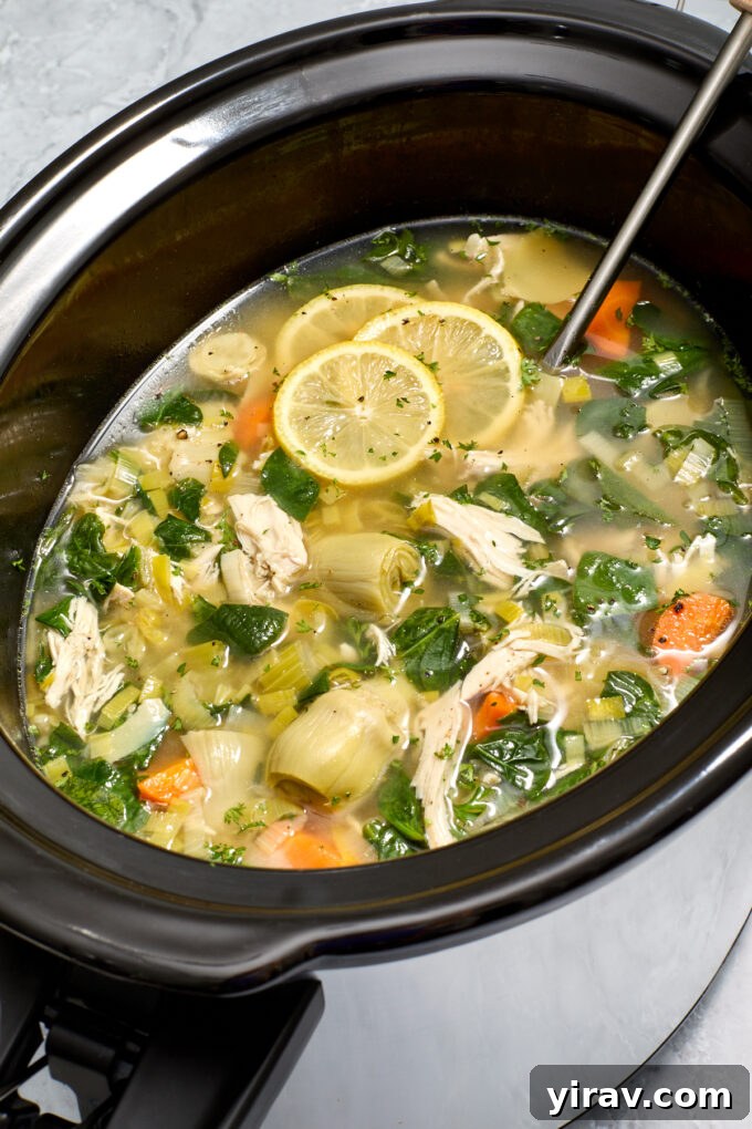 Lemon chicken soup with artichokes in slow cooker.