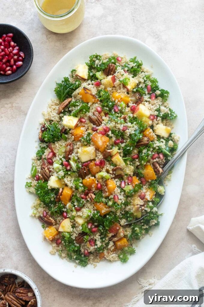 Platter of butternut squash and quinoa salad with a serving spoon, highlighting its inviting appeal.