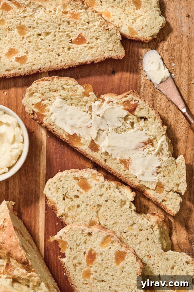 Irish soda bread without raisins, slathered with butter, ready to eat.