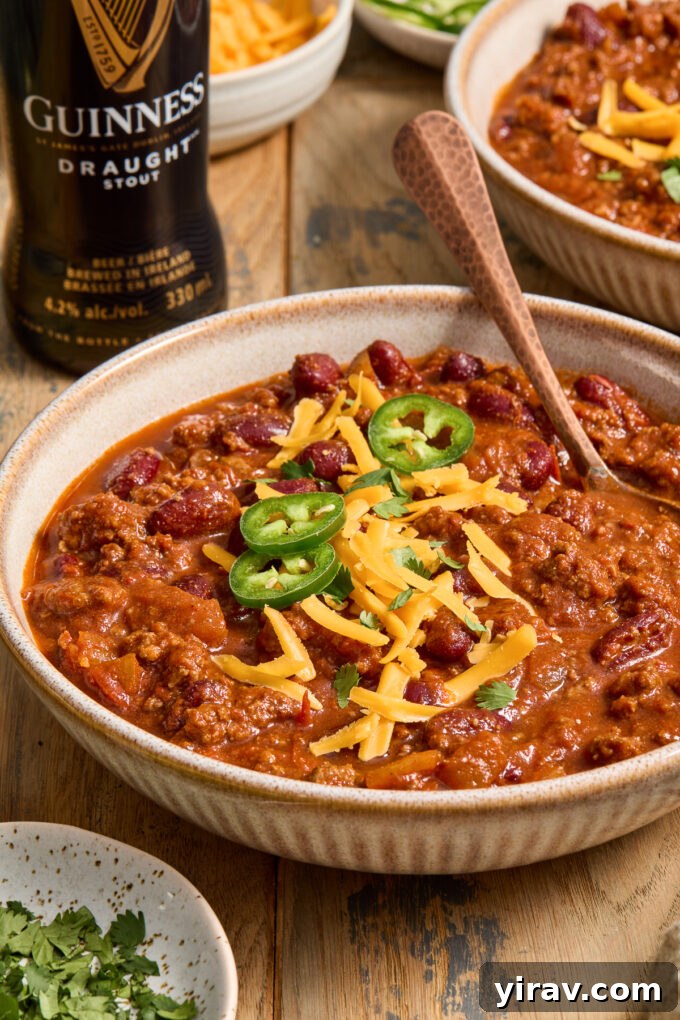Rich Guinness Chili 7 Guinness stout chili with ground beef in a bowl, garnished with cilantro.