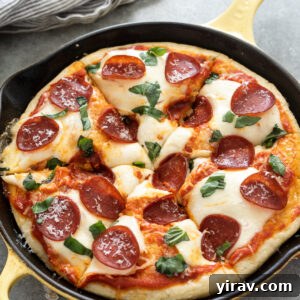 One hour focaccia pizza sliced in a skillet.