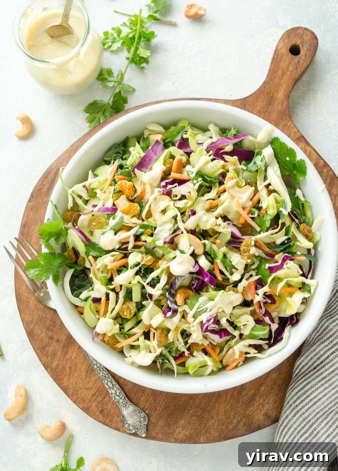 Golden Curry Coleslaw 2 Bowl of coleslaw on a wooden cutting board