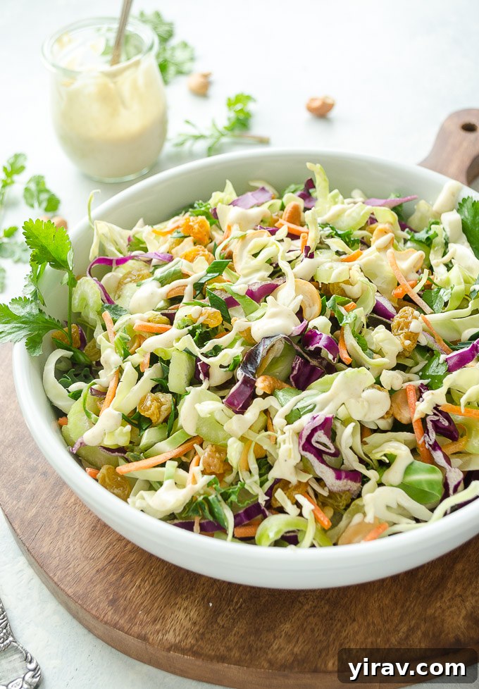 Golden Curry Coleslaw 5 Curry coleslaw in a white bowl with dressing in a jar