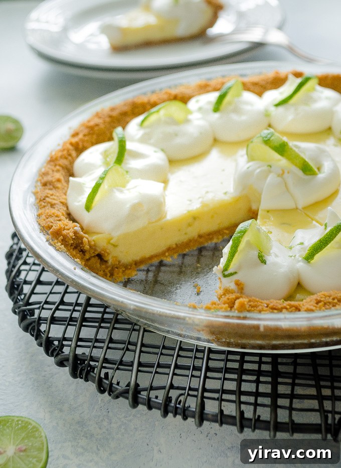 Key Lime Perfection 6 Key lime pie in pie plate with a slice missing, showing the creamy texture