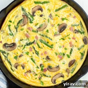 Golden Ham and Cheese Frittata 9 Ham and cheese frittata in a skillet, showcasing the finished dish.