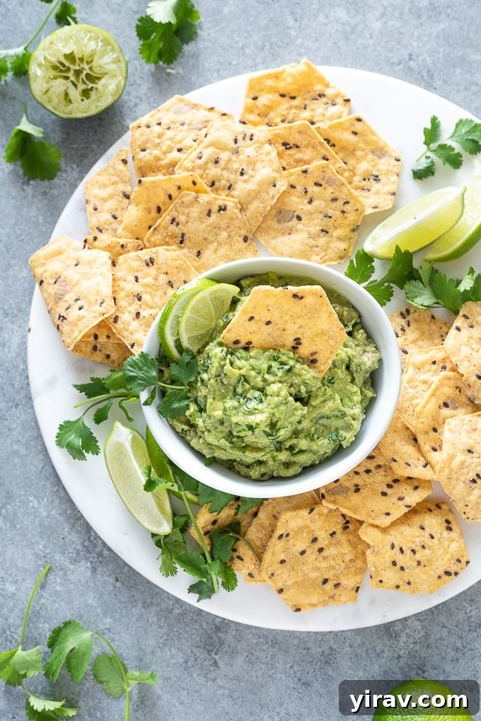 The Ultimate Homemade Guacamole Dip 8 Homemade guacamole with a chip dipped into the center