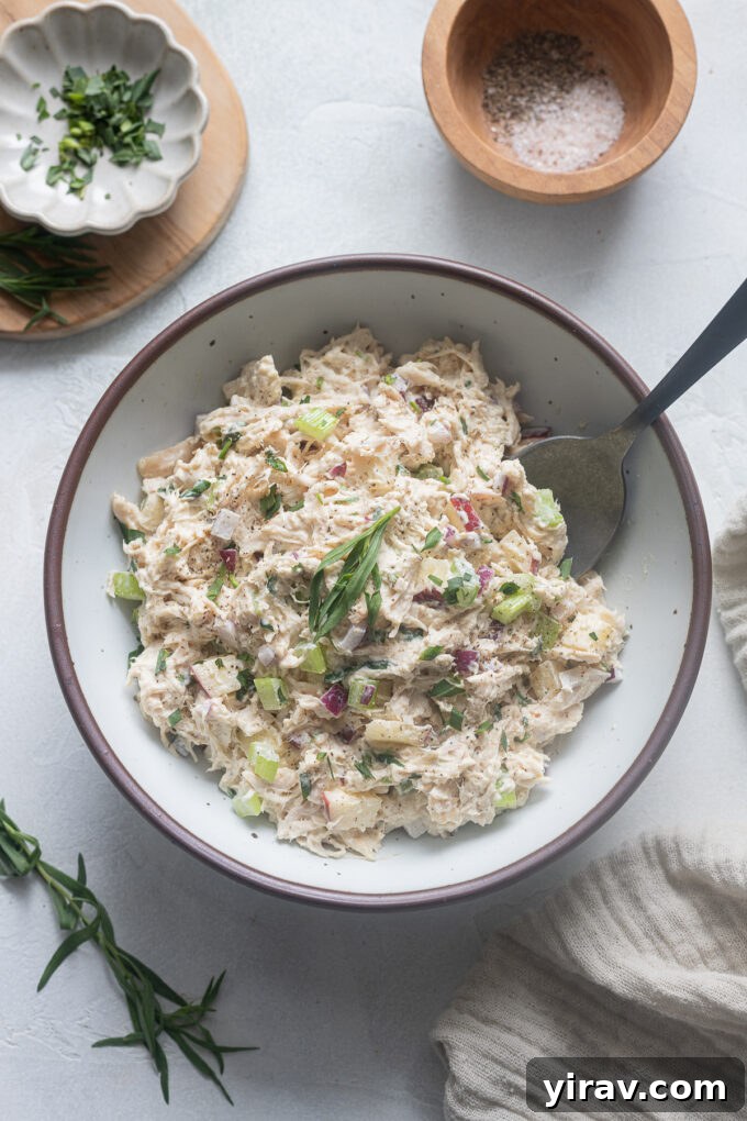 Chicken salad with tarragon and apples in a bowl.