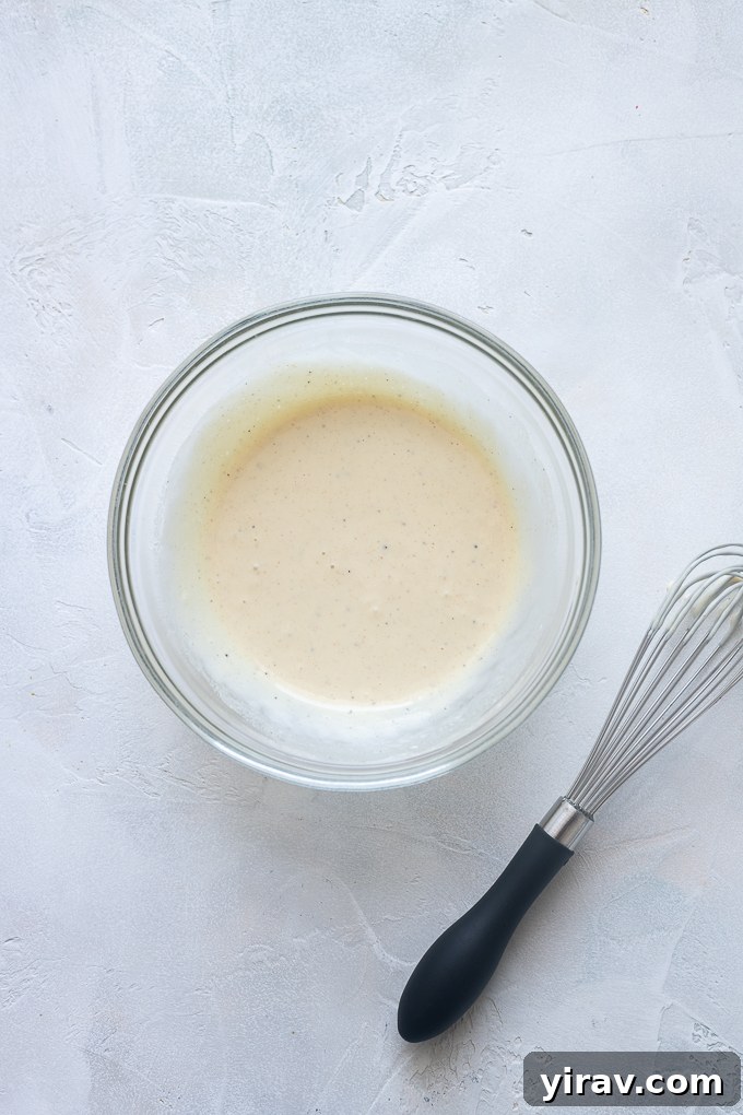 Dressing for tarragon chicken salad in a bowl.