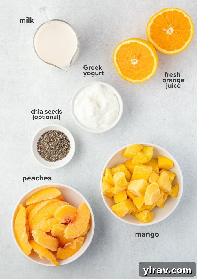 Sunshine Peach Mango Bliss 4 A flat lay photograph showcasing the key ingredients for a peach mango smoothie: sliced fresh peaches, frozen mango chunks, Greek yogurt, almond milk, and a small glass of orange juice.
