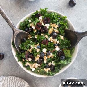 Cherry salad with salad servers digging into the bowl