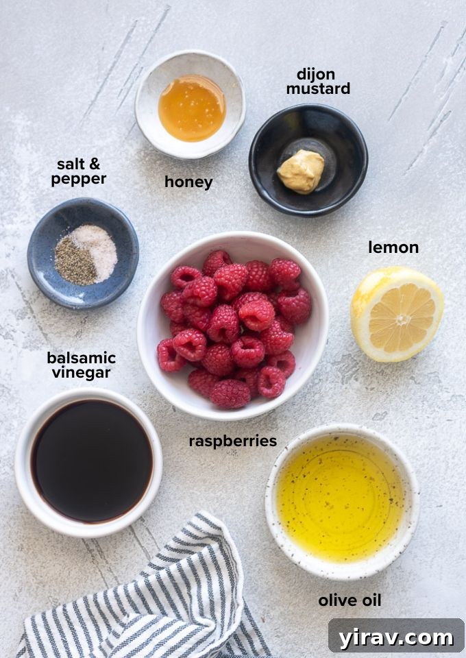 Vibrant Raspberry Vinaigrette 4 A selection of fresh ingredients including raspberries, olive oil, and vinegar, laid out for making raspberry vinaigrette dressing.