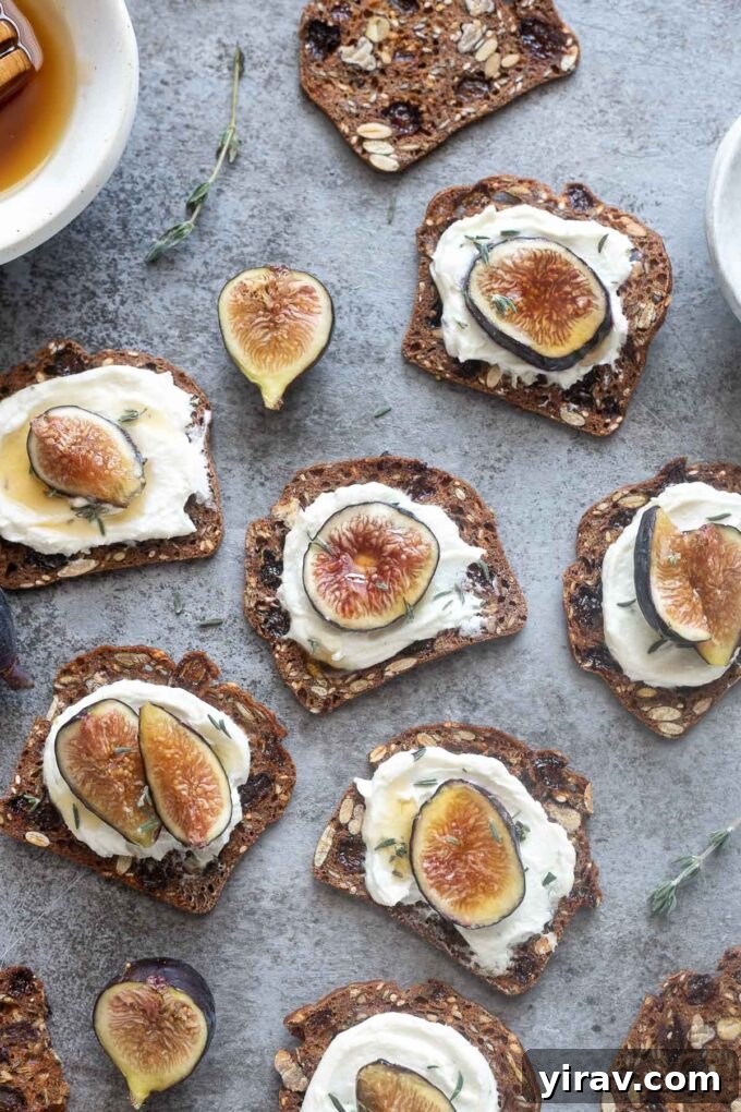 Whipped goat cheese generously spread on rustic crackers, adorned with fresh fig slices and a glistening honey drizzle, artfully arranged for serving.