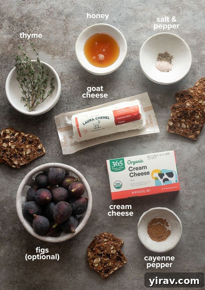 Essential ingredients for whipped goat cheese laid out: a log of goat cheese, a block of cream cheese, a jar of honey, fresh thyme sprigs, and a small bowl of cayenne pepper.