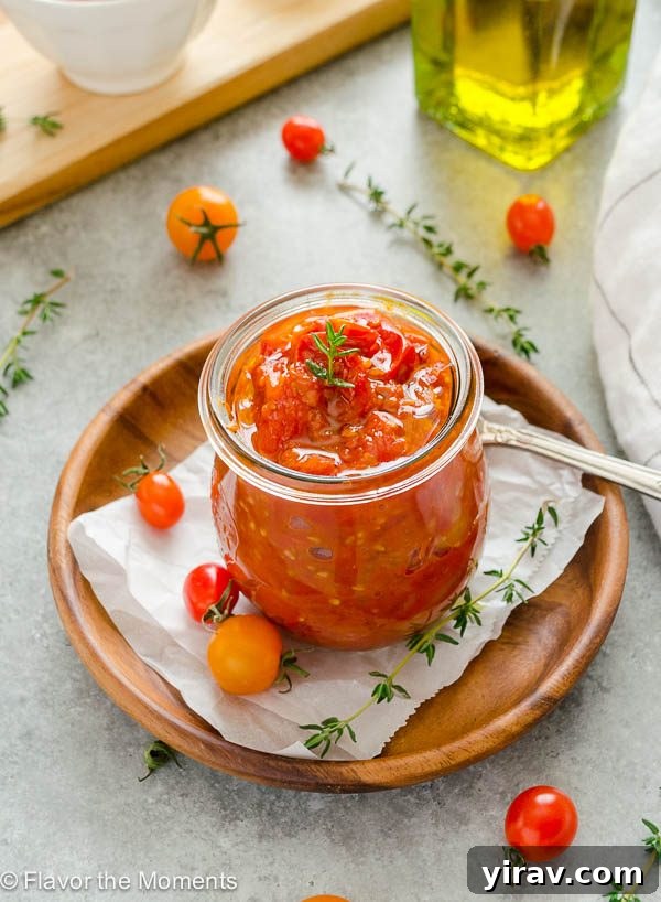 Front shot of vibrant cherry tomato jam in a clear glass jar, ready to be enjoyed as a versatile condiment.